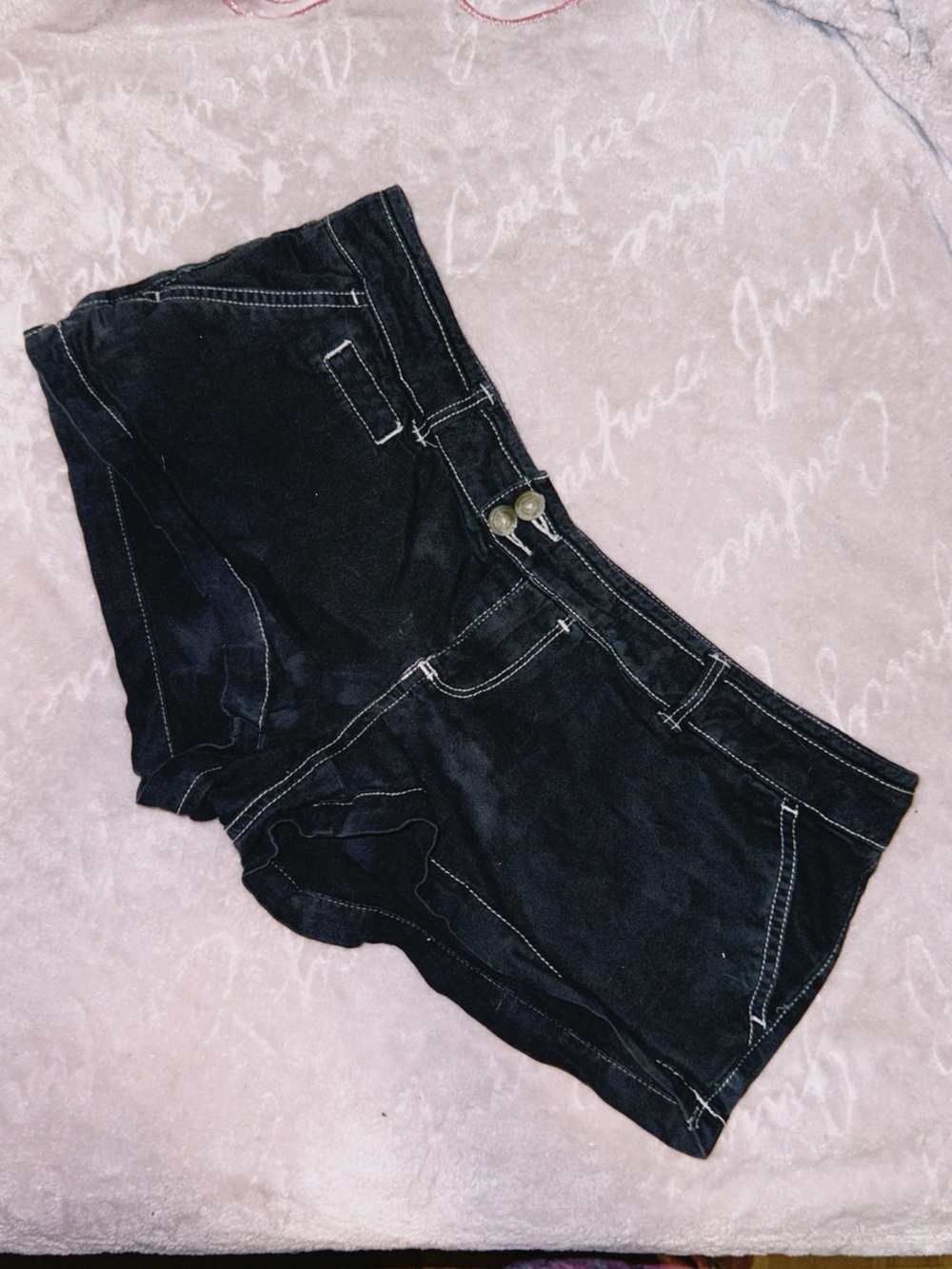 Low rise American Eagle black shorts with white stitching.